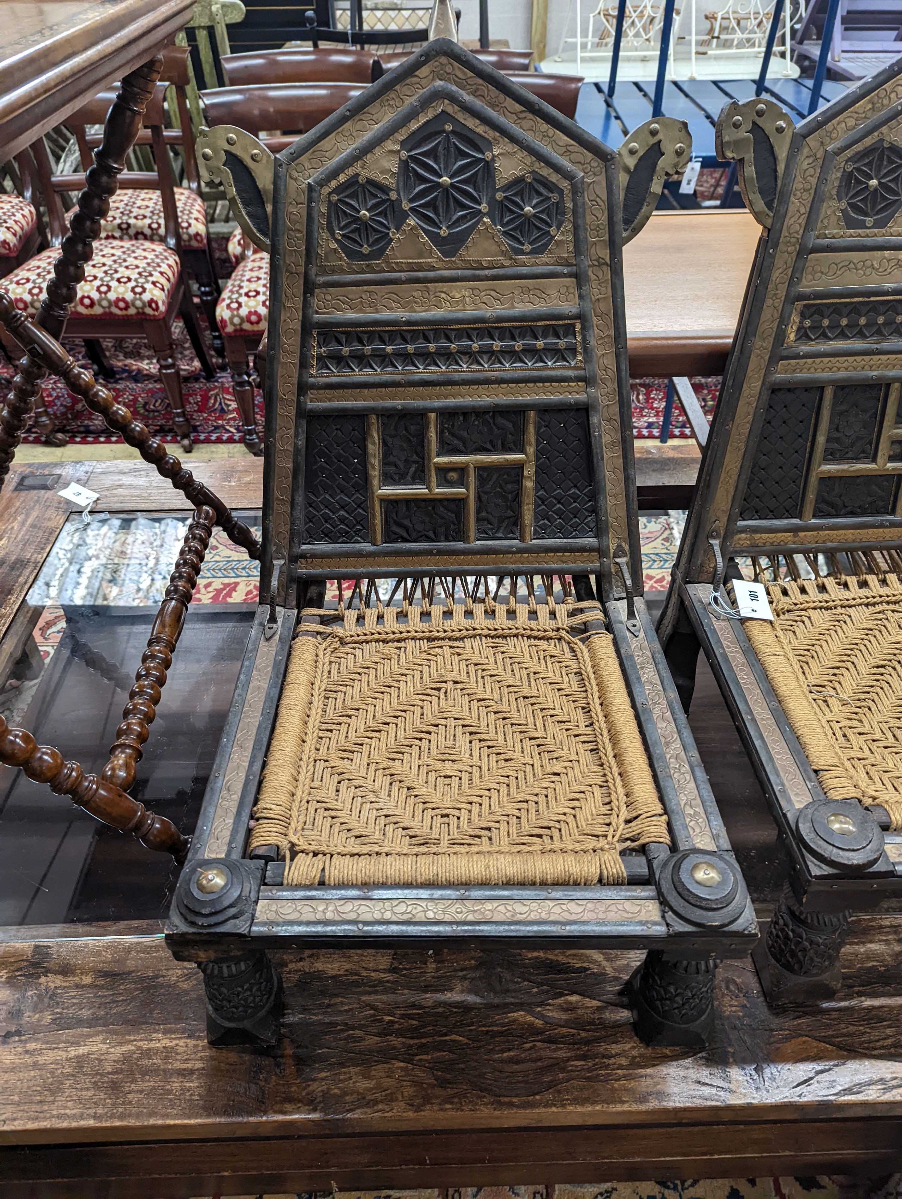 A pair of Afghan chip-carved and brass-mounted low seat chairs with woven seats, width 45cm, depth 45cm, height 76cm